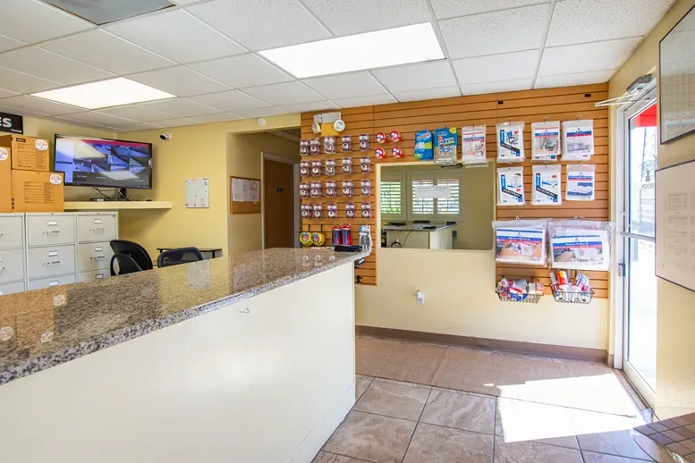 Storage office with customer service desk, security monitoring, and packing supplies
